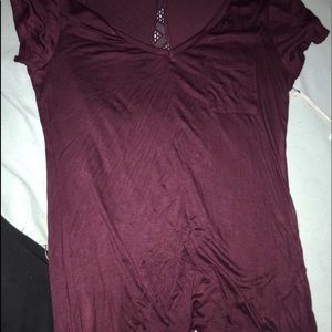 burgundy top with a see they design on the back